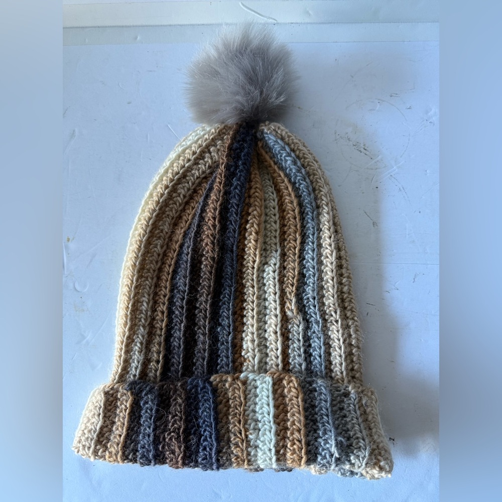 Ladies knit winter hat with grey palm, shades of blue, brown and tan